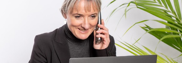 Business woman at Adept IT Solutions using a cost effective VoIP phone