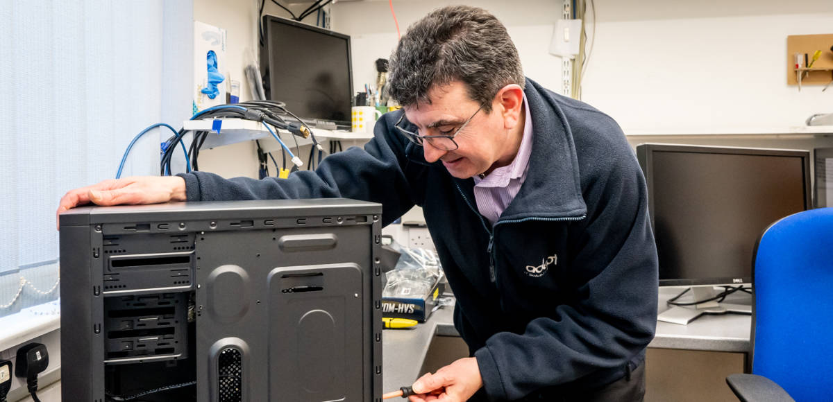 James repairing a tower PC